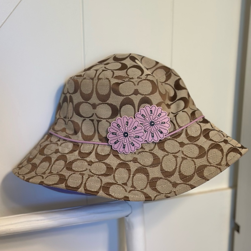 Coach signature brown hat  with purple flowers/trim M/L. Like new